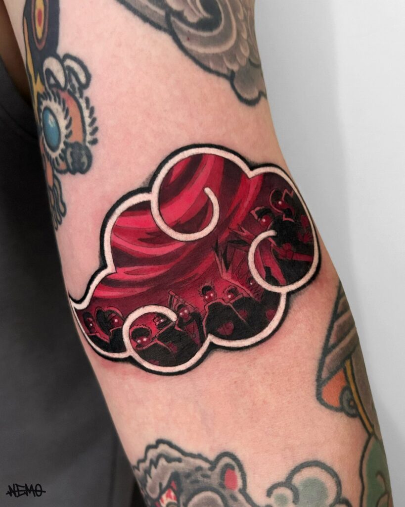Akatsuki cloud tattoo on an arm featuring red colors and character silhouettes.