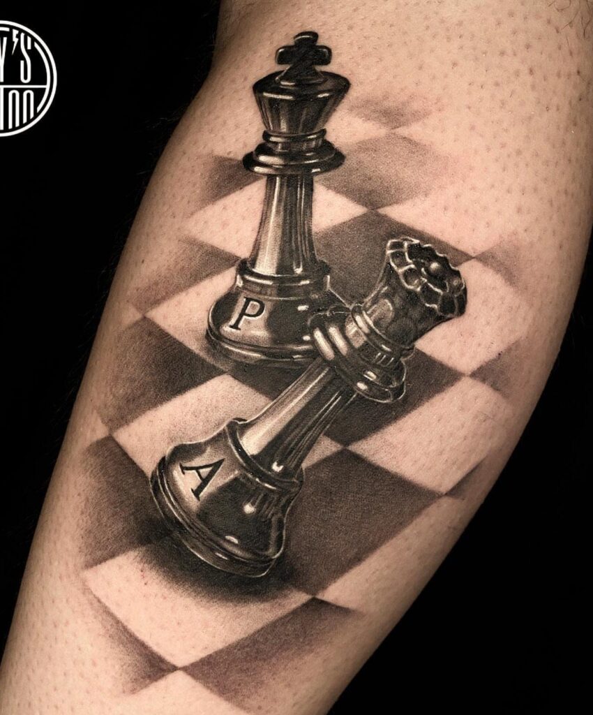 Chess piece tattoo showing a king and fallen queen on a checkered board.