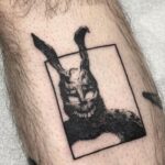 Donnie Darko Frank the rabbit tattoo on a person's leg in black ink