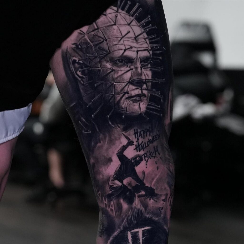 Horror movie tattoos on a leg featuring Pinhead and other spooky imagery.
