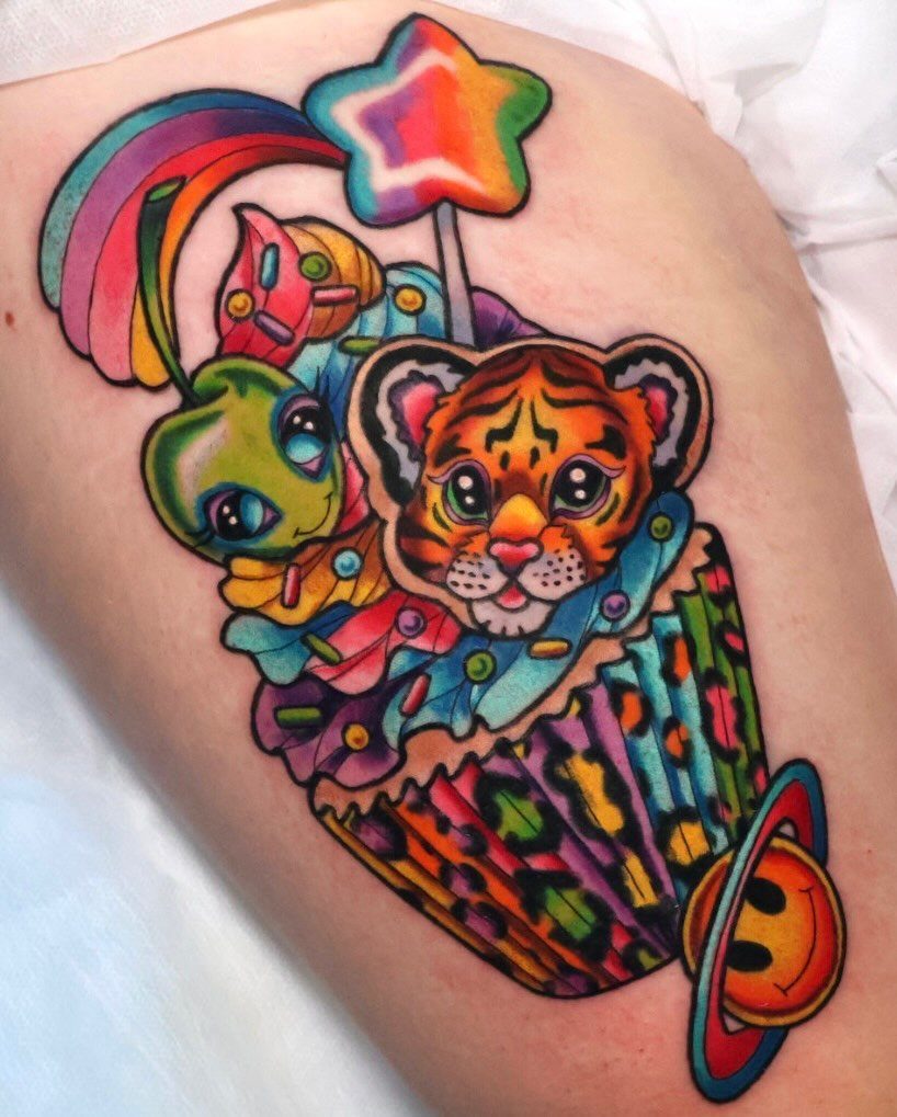 Colorful tattoo of a tiger cub in a rainbow cupcake with a smiley planet.