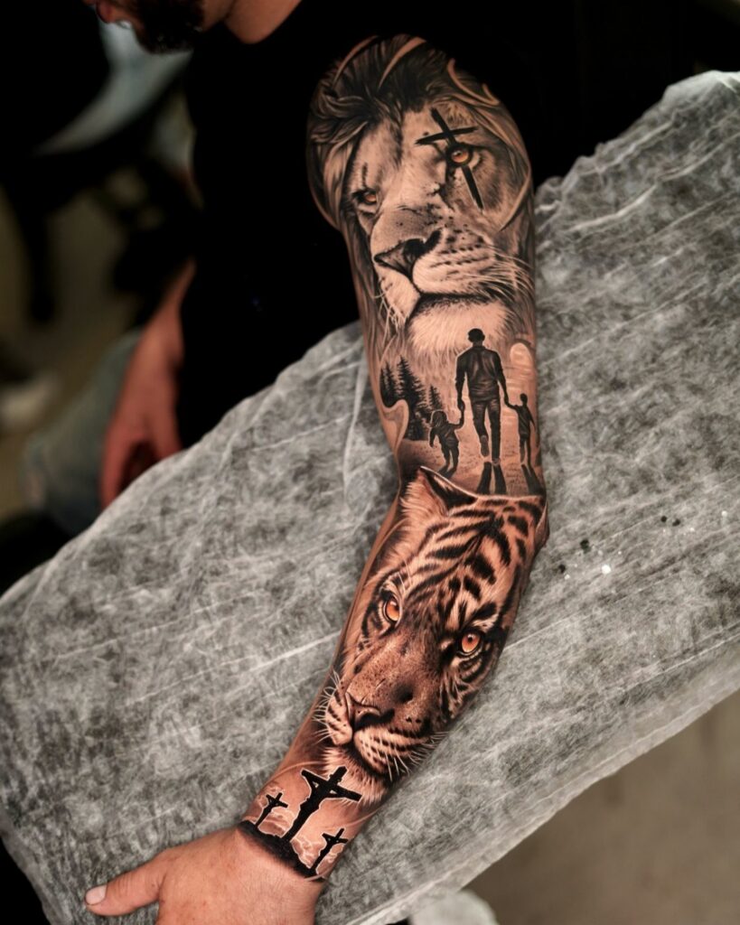 Detailed black and grey tattoo sleeve on a man's arm featuring lions and tigers.