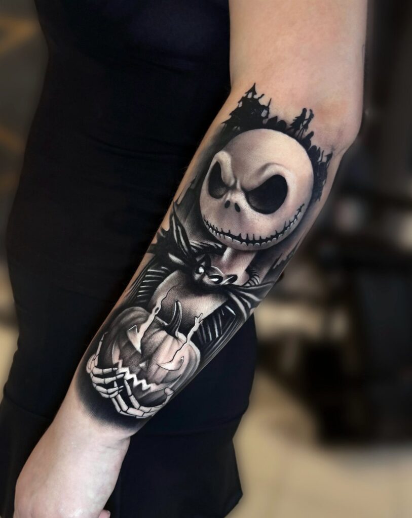 Jack Skellington tattoo on a forearm holding a carved pumpkin in black and grey.