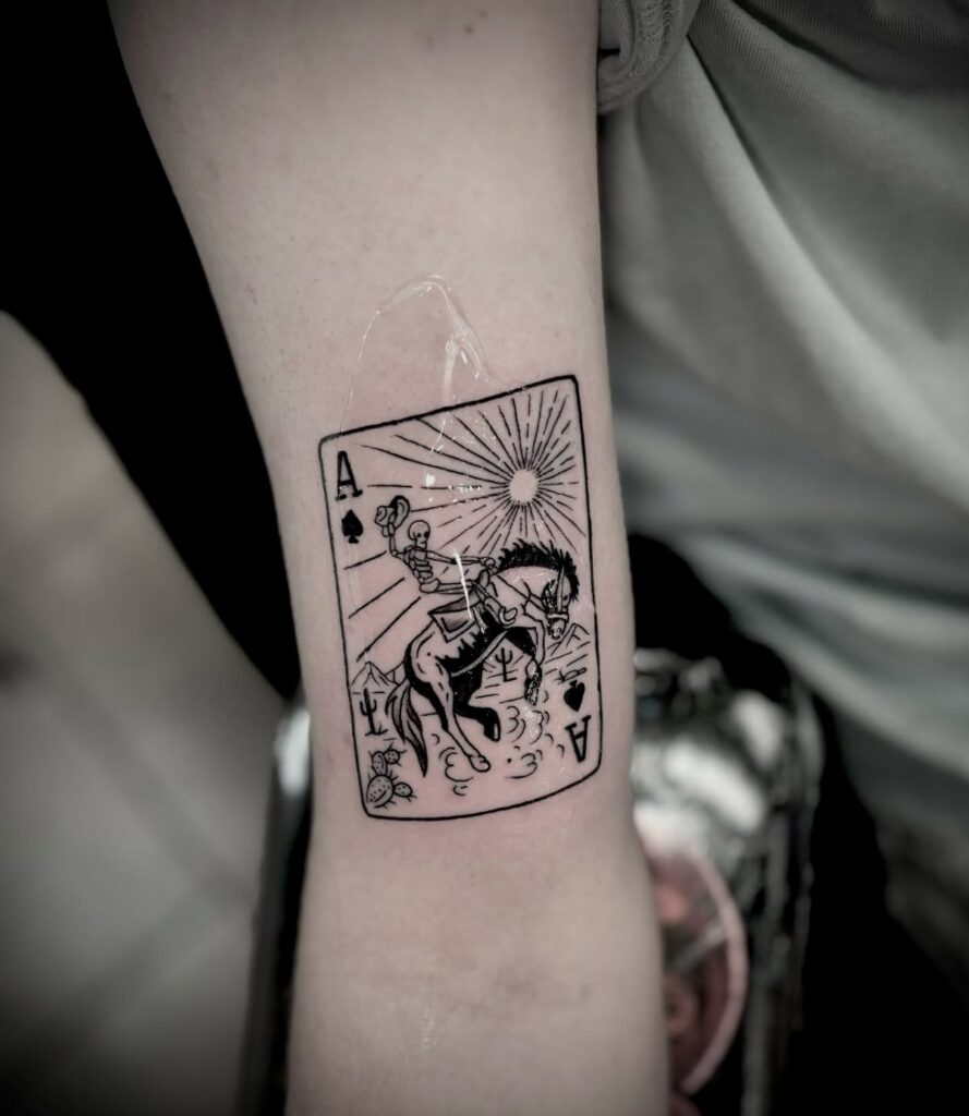 Ace of spades playing card tattoo featuring a skeleton riding a horse.