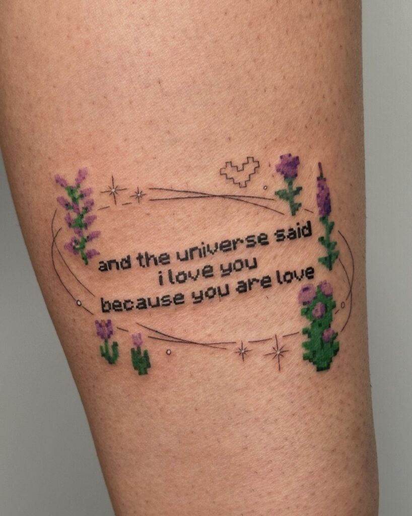 Pixel art tattoo with purple flowers and a quote on human skin.